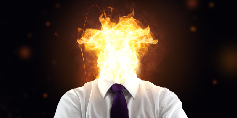 Man in business attire with flames in place where his head was supposed to be Man in business attire with flames in place where his head was supposed to be
