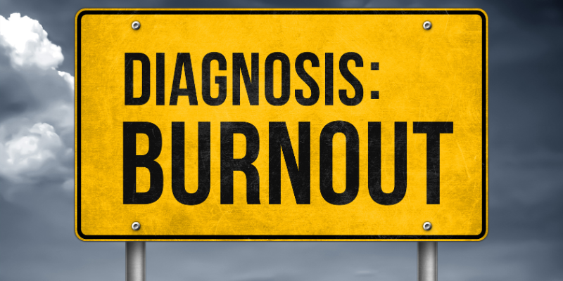 A signboard with the words "Diagnosis: Burnout" on it A signboard with the words "Diagnosis: Burnout" on it