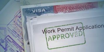 An approved work permit on a United States visa, laid on a stamped passport