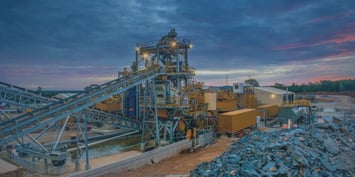 An industrial plant with a conveyor belt, representing the coal mining sector's job diversity and its shift toward cleaner energy.