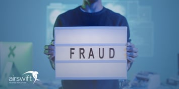 Person holding a lightbox sign reading “fraud”, highlighting job applicant scam awareness.