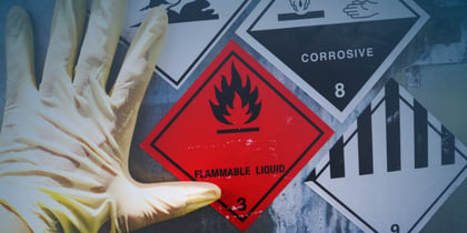 Individual wearing gloves displays a hazardous substance sign, highlighting the importance of safety in chemical environments.