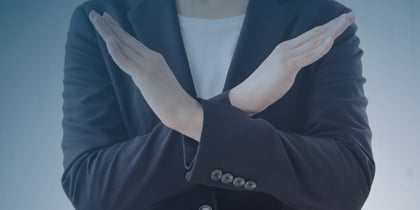 A woman in a business suit makes a hand gesture, illustrating key points about declining job offers in a professional context.