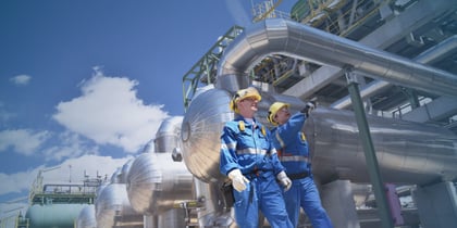 Oil and gas professionals inspecting equipment at an industrial facility