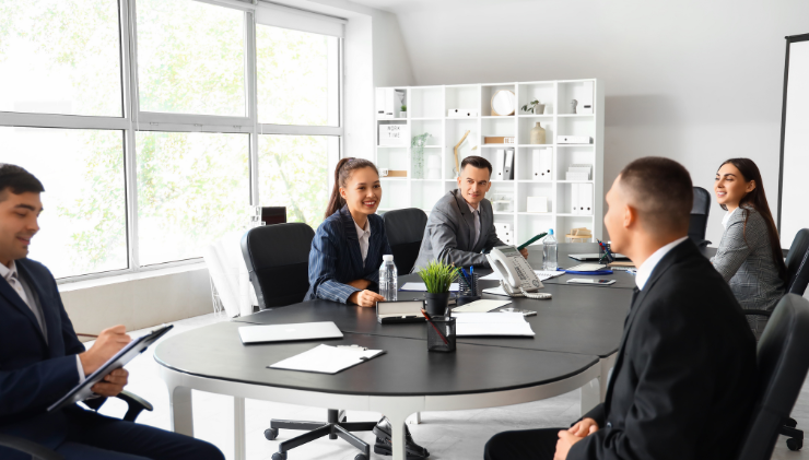 People in business attire at a conference table