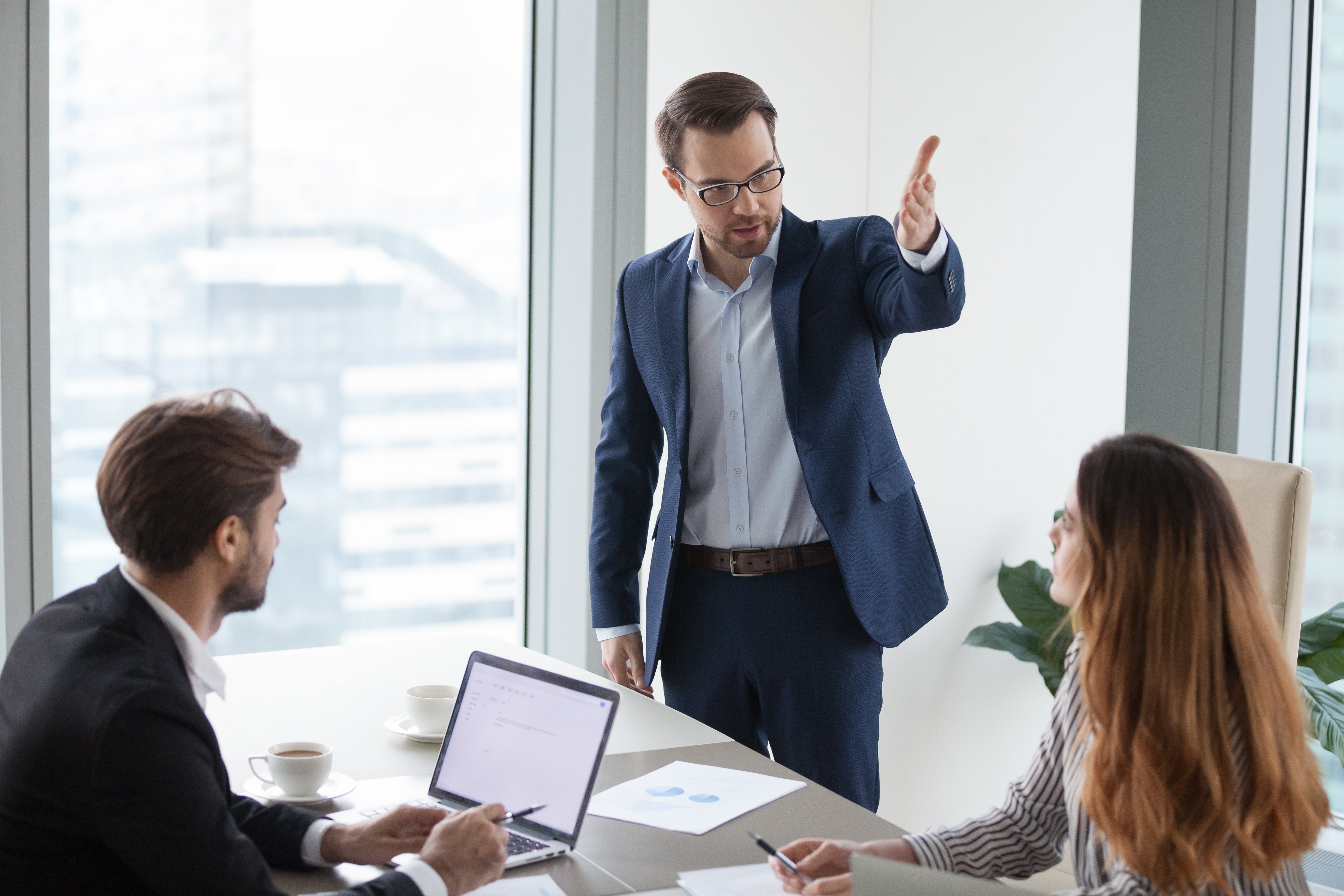 Rude angry boss executive demanding to leave meeting dissatisfied irritated by female colleague, mad annoyed businessman firing businesswoman employee as gender discrimination and harassment concept