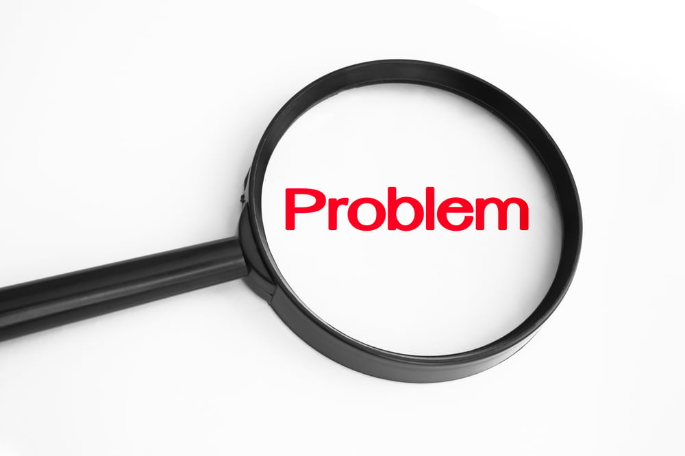 A magnifying glass over the word "problem".