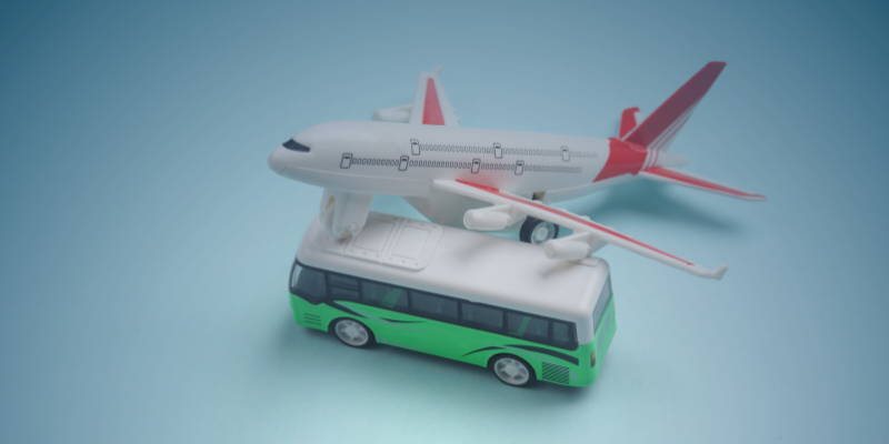 A toy airplane and a bus on a blue background, illustrating the significance of FIFO, DIDO, and BIBO models in modern work environments.