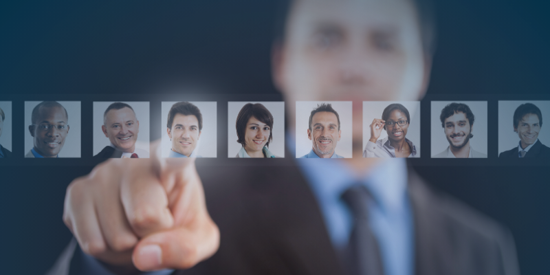  A suited man gestures towards a group of professional headshots, highlighting the importance of adapting workforce strategies in a changing economy.
